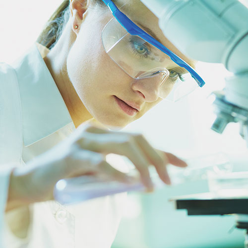 Scientist in lab with beaker